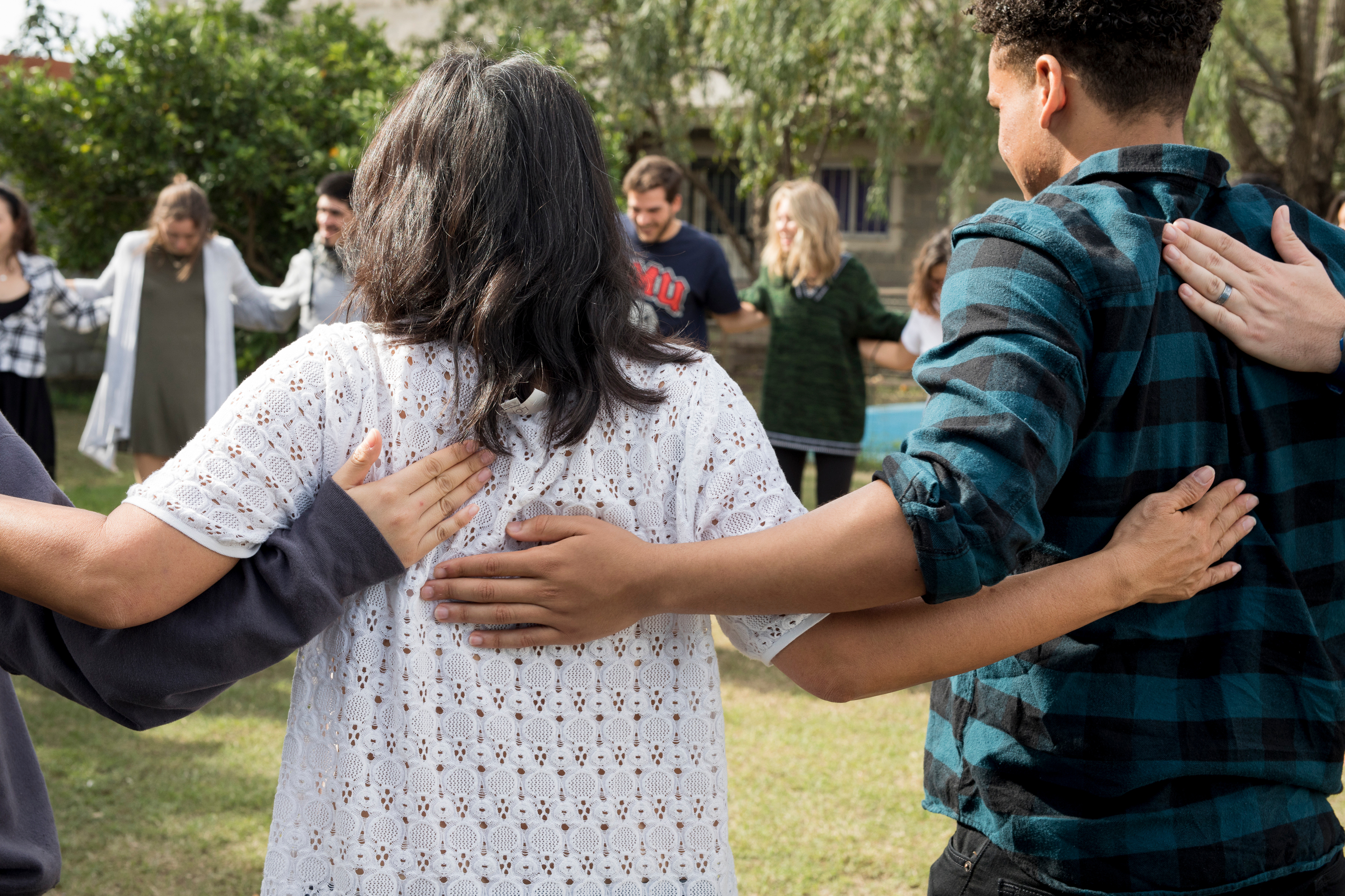 Students linking arms in a circle